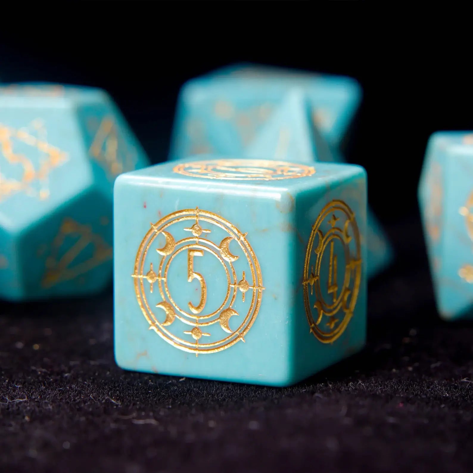 Close-up of a single Green Howlite D6 die with engraved pips 
