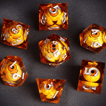 Vibrant orange full set of Moving Eyes D&D dice by URdice. The warm-colored resin contrasts with the watchful eyes inside the liquid cores.