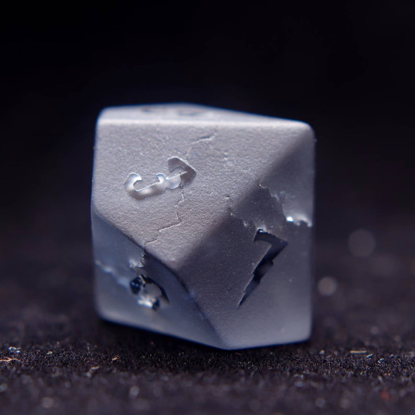 The percentile D10 gemstone dice, poised for a dnd dice roll, highlighting the unique matte finish and numbers.