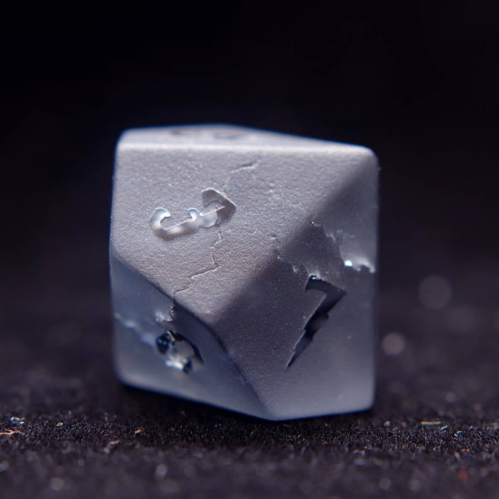 The percentile D10 gemstone dice, poised for a dnd dice roll, highlighting the unique matte finish and numbers.