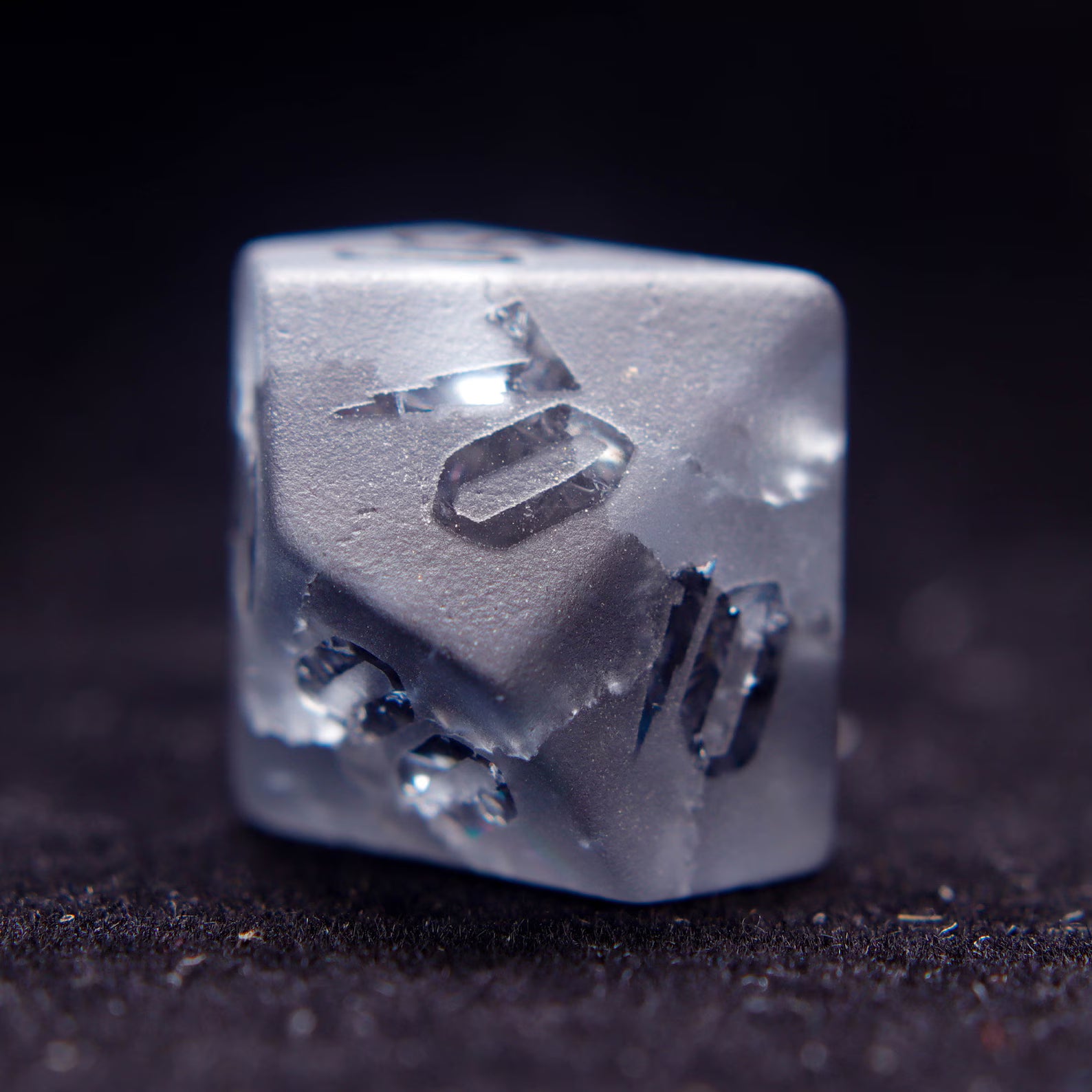 The percentile D% gemstone dice, poised for a dnd dice roll, highlighting the unique matte finish and numbers.