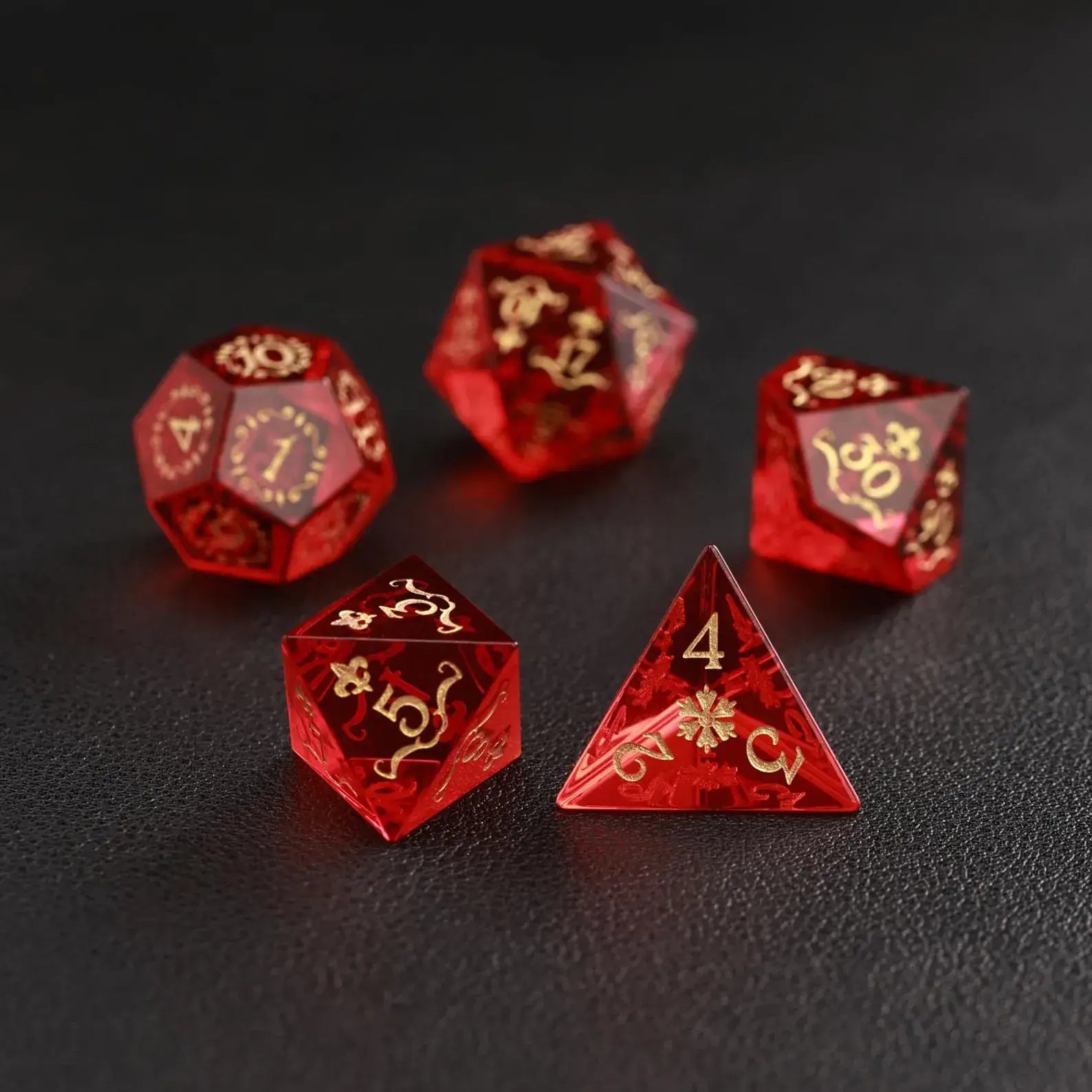 Stack of three weighted Garnet D6s on black background, showcasing the density of the natural stone dice.