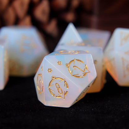White carved opal D10 showing soft iridescent reflections across its stone-like surface.
