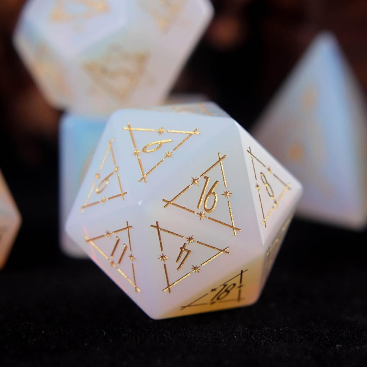 White carved opal D20 featuring frost-like opal shimmer and deep engraved numerals.