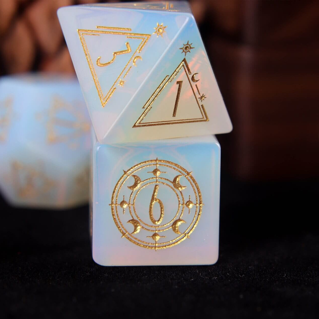 White carved opal D4 triangular die reflecting a bright, crystal-like luminosity.